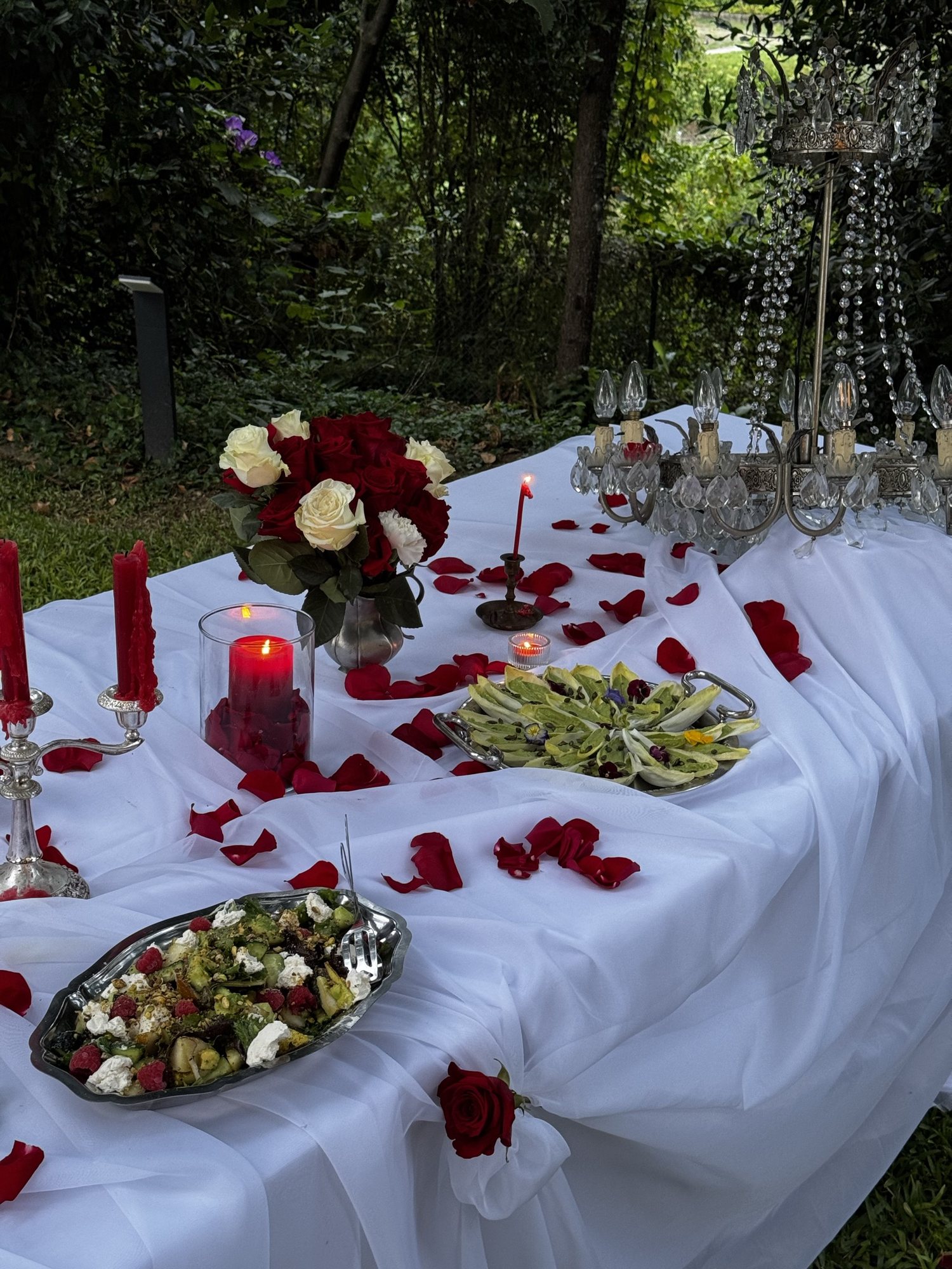 Rose petals across white linen