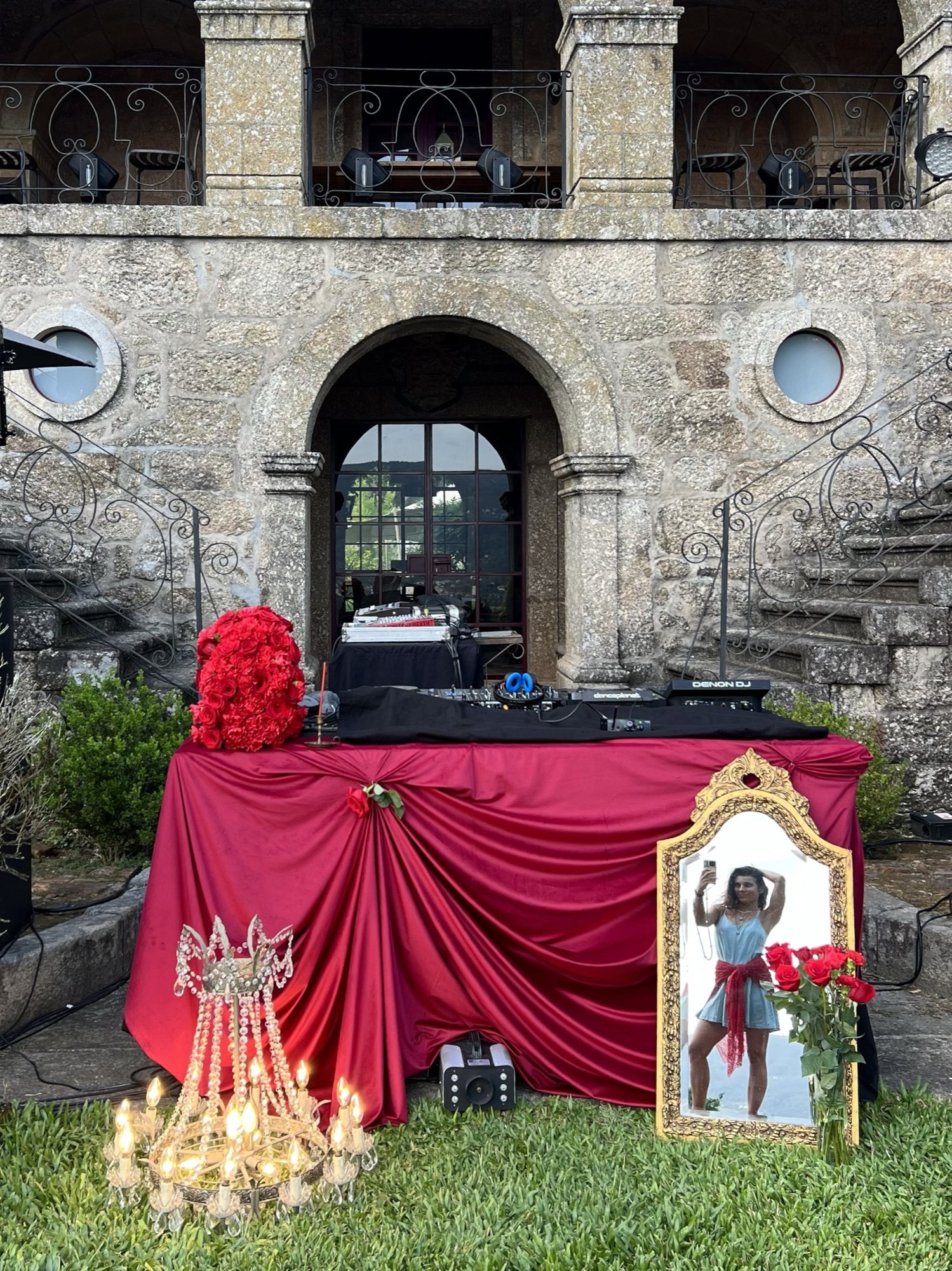 Crimson drape and candles against stone